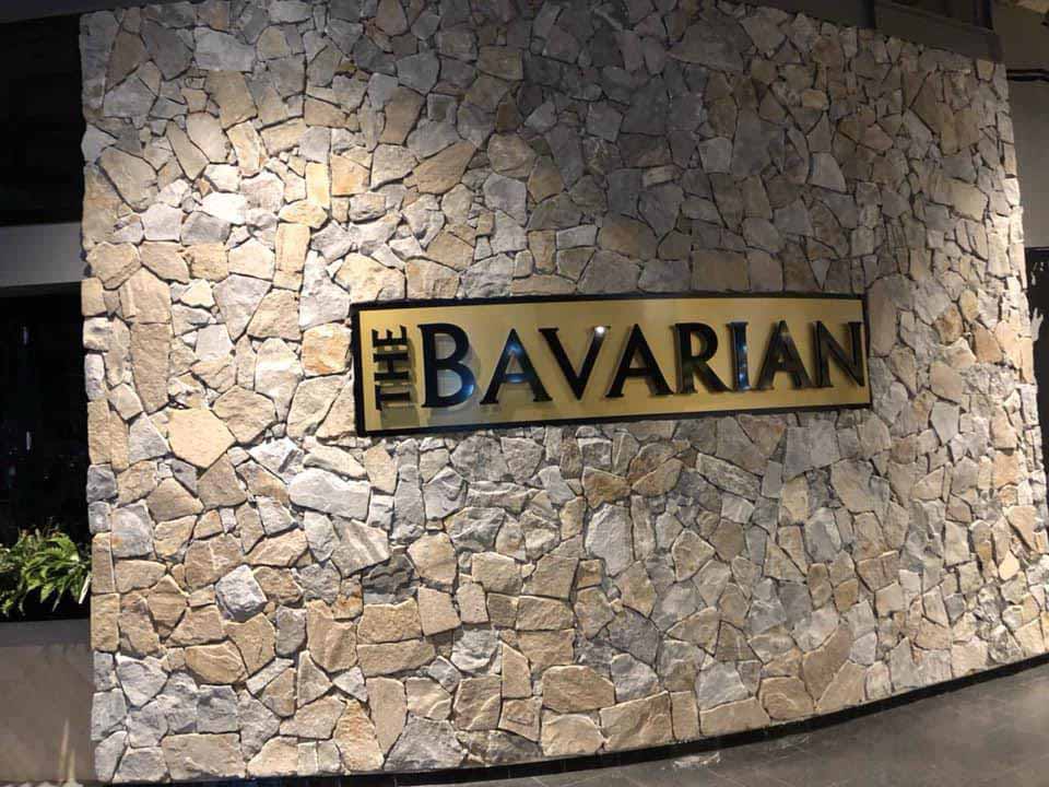 Natural stone feature wall with a The Bavarian sign, wide view
