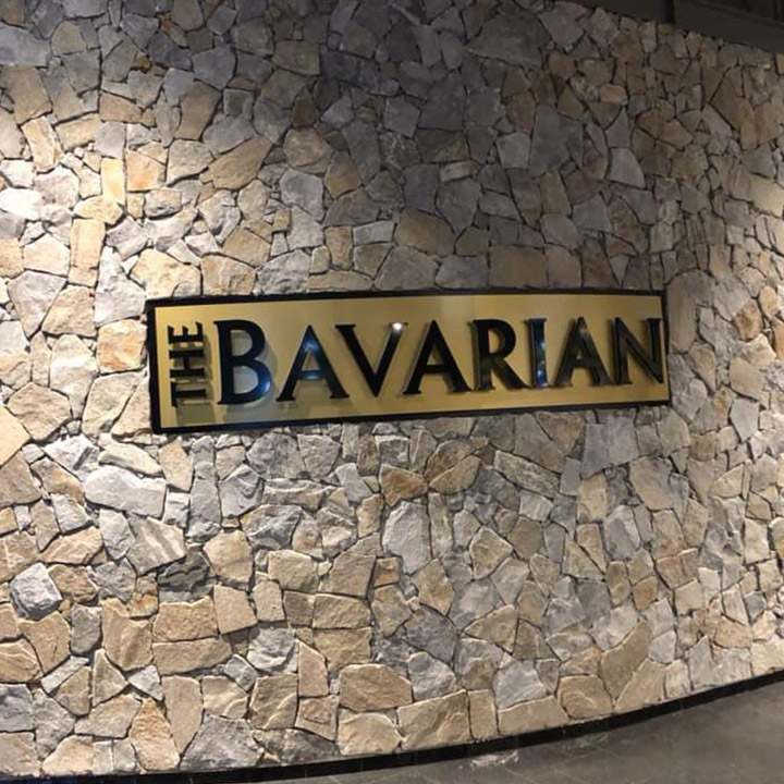 Natural stone feature wall with a The Bavarian sign, close-up